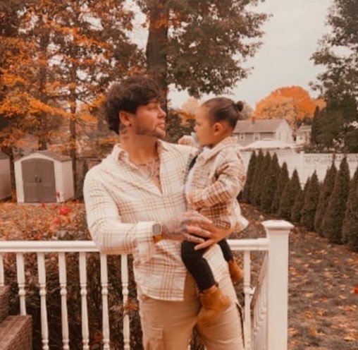 Father and child in matching outfits during autumn