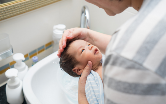 mom bathing a baby