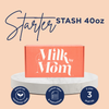 Milk by Mom Starter Stash 40oz box displayed on a round marble stand. Text above reads 'Starter Stash 40oz.' Icons below highlight benefits: preserves nutritional value, custom label and instructions, and 3-year shelf life.