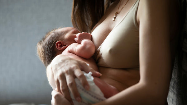 Mother breastfeeding her newborn baby in a calm setting