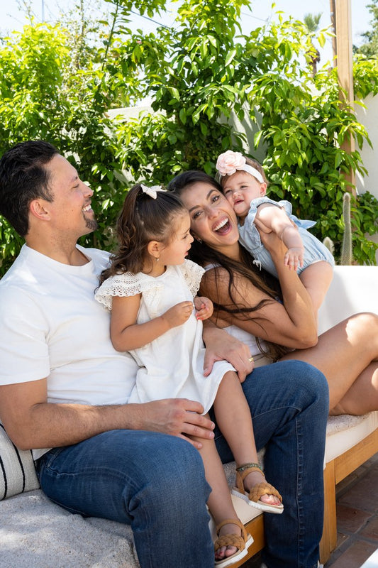 Smiling family with two young children enjoying time outdoors