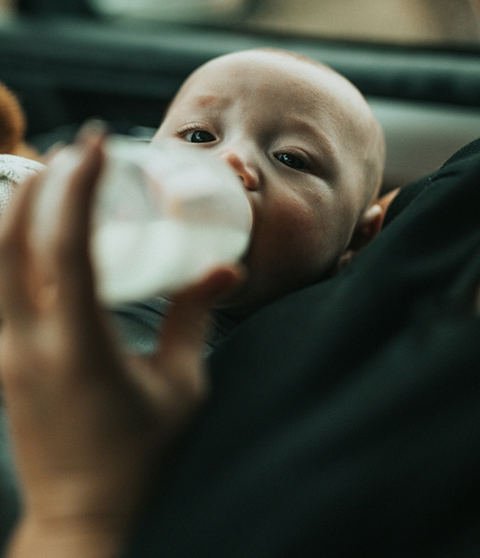 baby drinking a bottle of formula