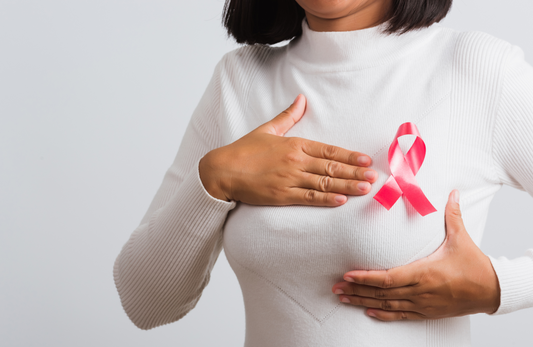 a woman wearing a pink breast cancer awareness ribbon