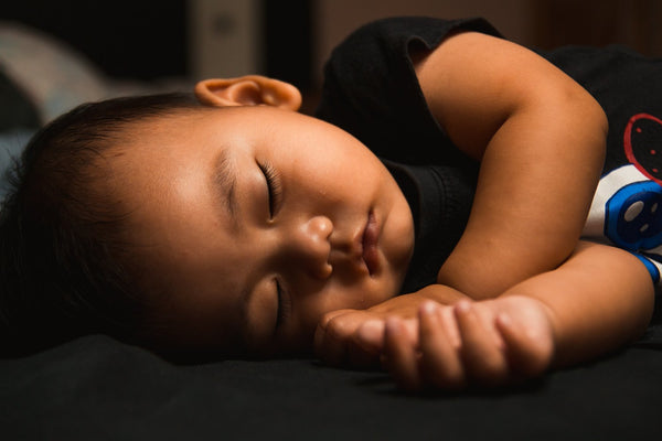 Sleeping baby resting peacefully on a bed