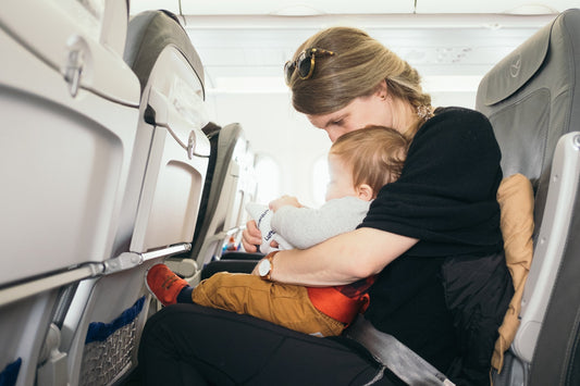 Mom nursing baby on airplane seat