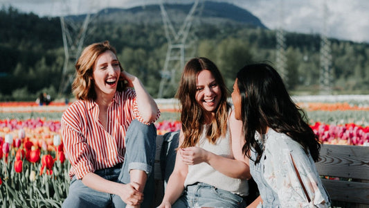 "Friends laughing in a tulip field on a sunny day