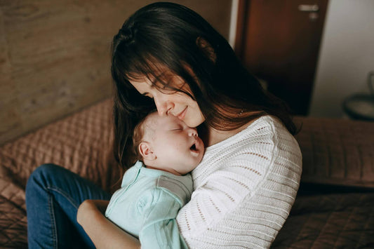 Mother cuddling newborn baby during bonding time, nurturing breast milk feeding and postpartum care at home