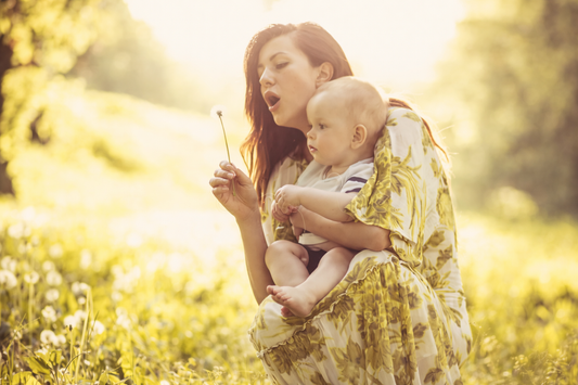A mama and her baby soaking in golden sunlight, sharing a quiet, curious moment